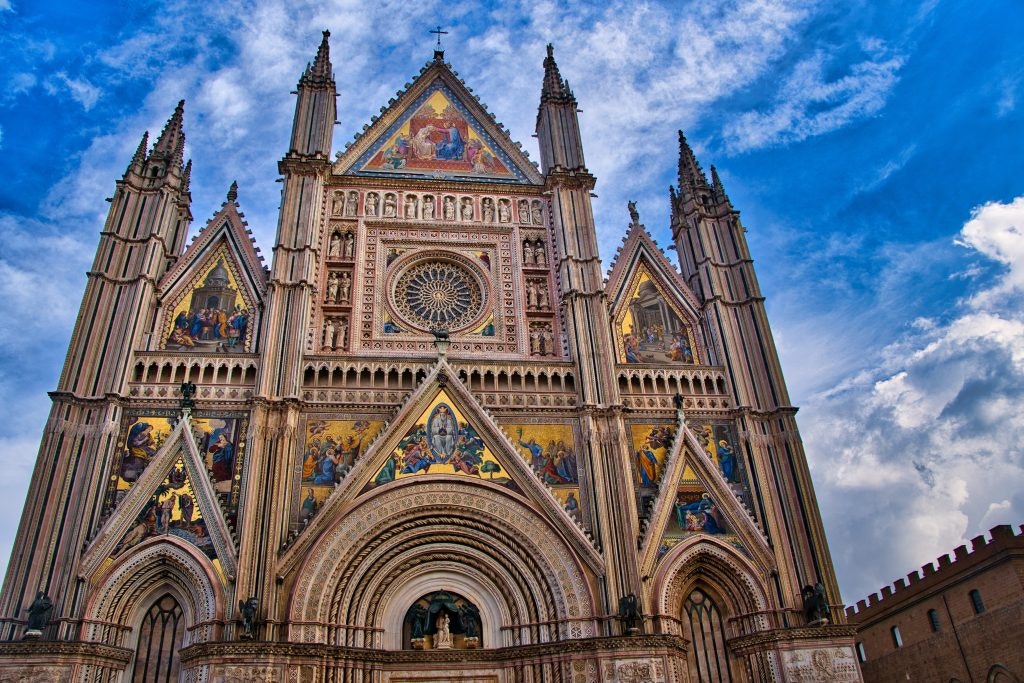 The Orvieto Cathedral with its ornate facade covered in colorful mosaics.