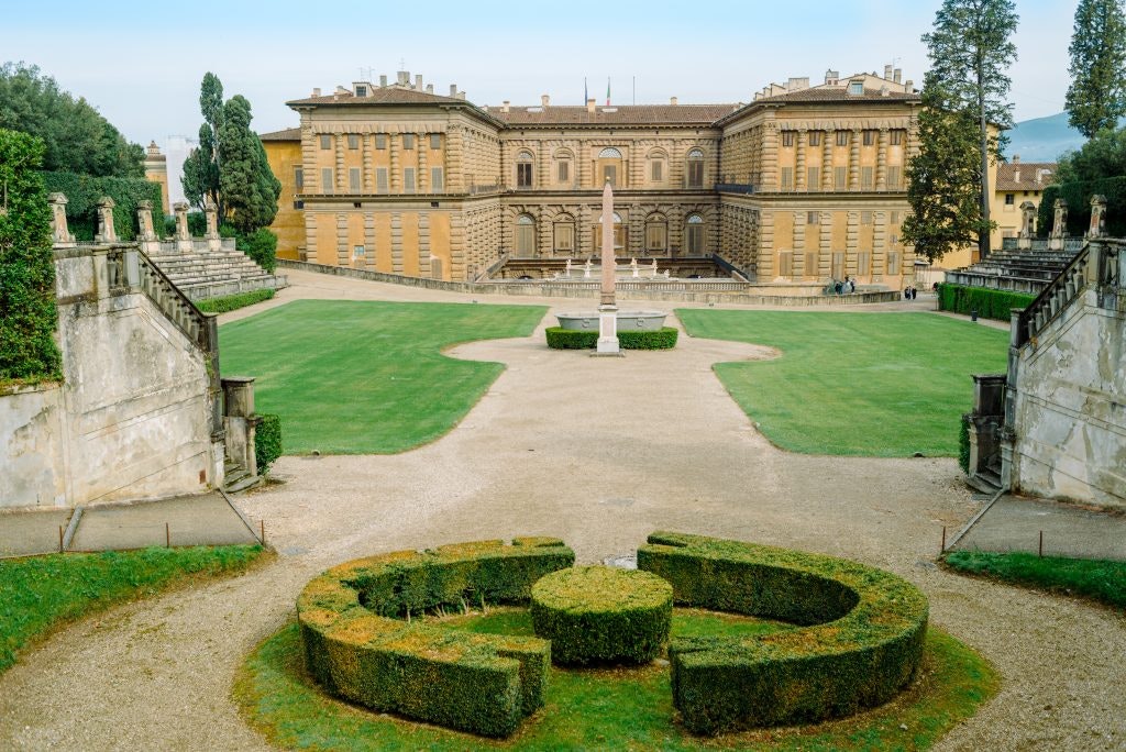 The Pitti Palace in Florence with its symmetrical gardens and central obelisk.