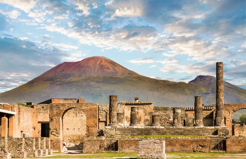 The ancient ruins of Pompeii with Mount Vesuvius in the background.