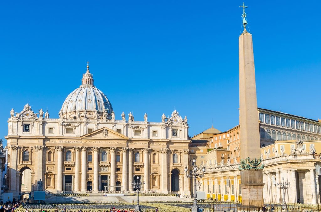 St. Peter’s Basilica in Vatican City with a towering obelisk in the foreground.