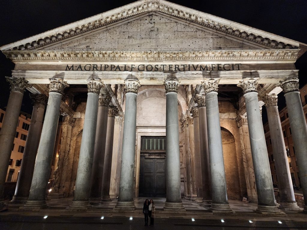 The Pantheon in Rome illuminated at night, showcasing its massive columns. famous buildings in italy