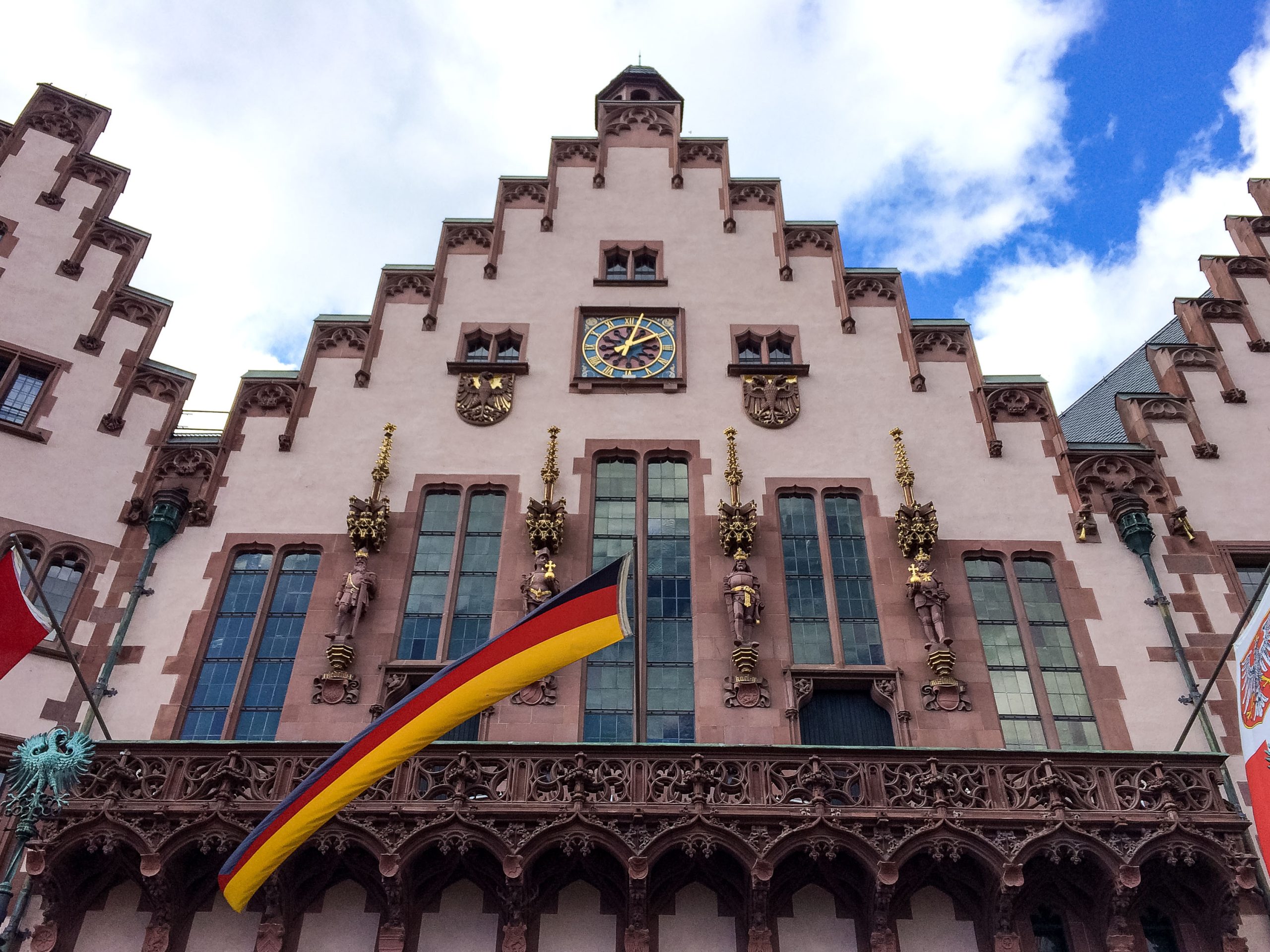 Fun facts about Germany: Facade of a historical building in Frankfurt with a German flag.