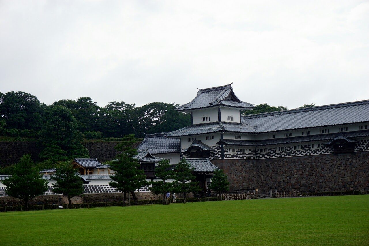 Kanazawa Castle&rsquo;s white plaster turrets and stone ramparts rise above a wide lawn