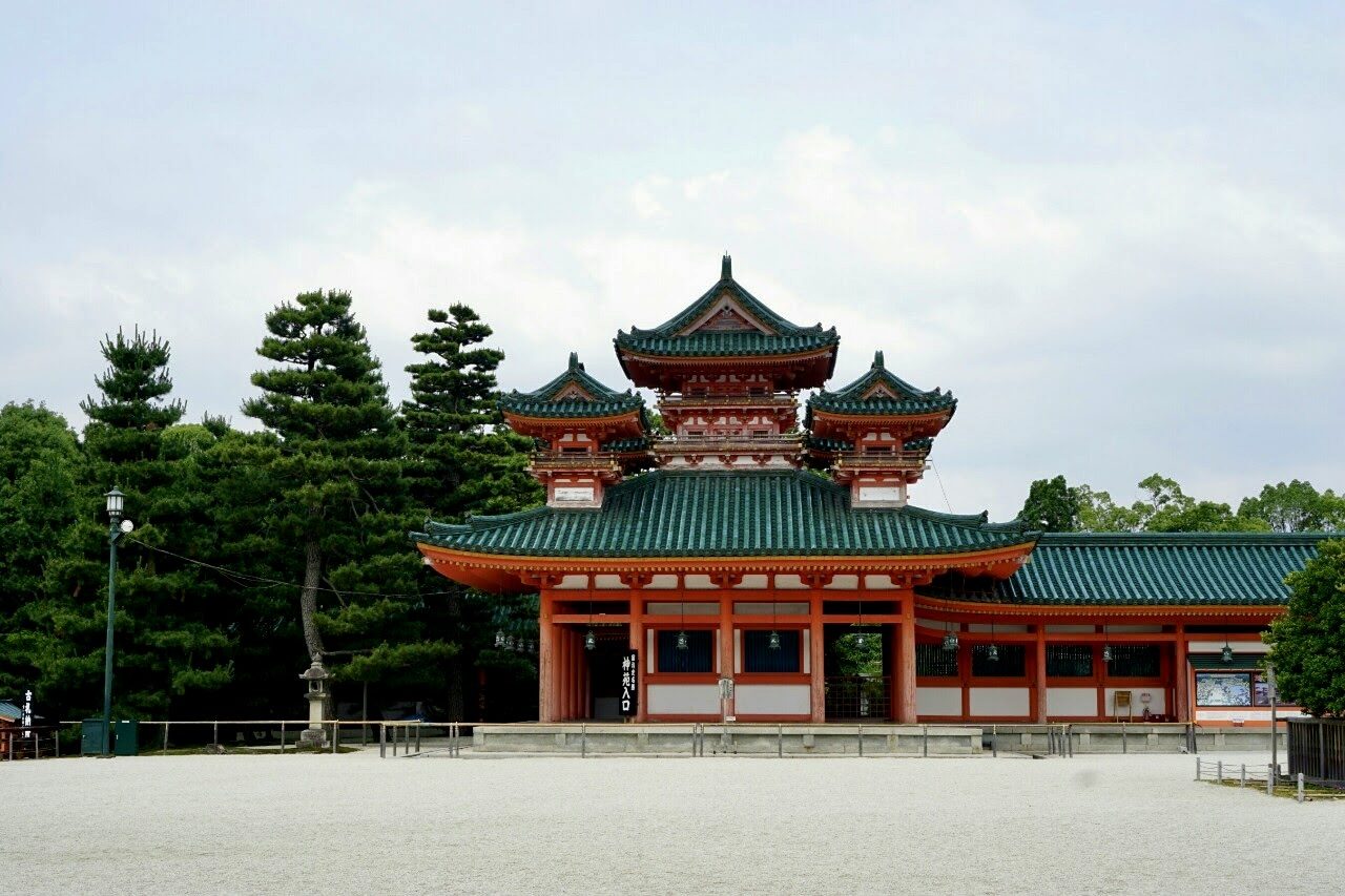 The Soryu-rō tower and green tiled roofs of Heian Shrine stand across a wide gravel court in Kyoto