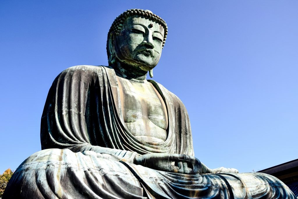 Japanese Buddha sculpture with a mudra representing firm faith.