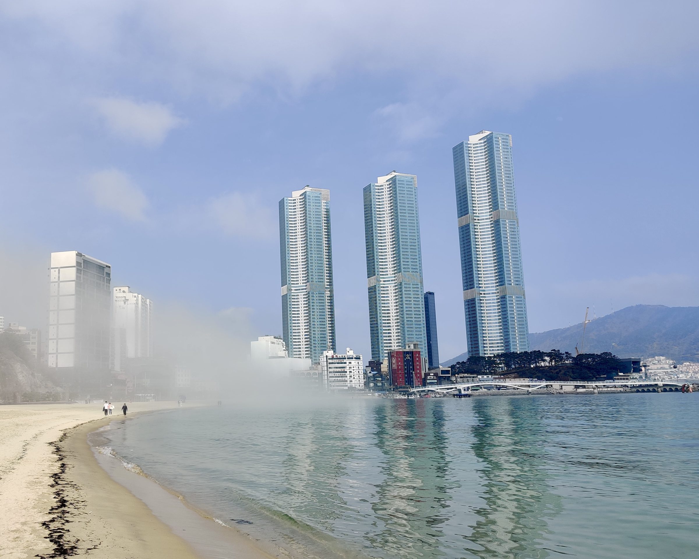 Sea mist rolls in over Haeundae Beach below Busan's high-rise towers