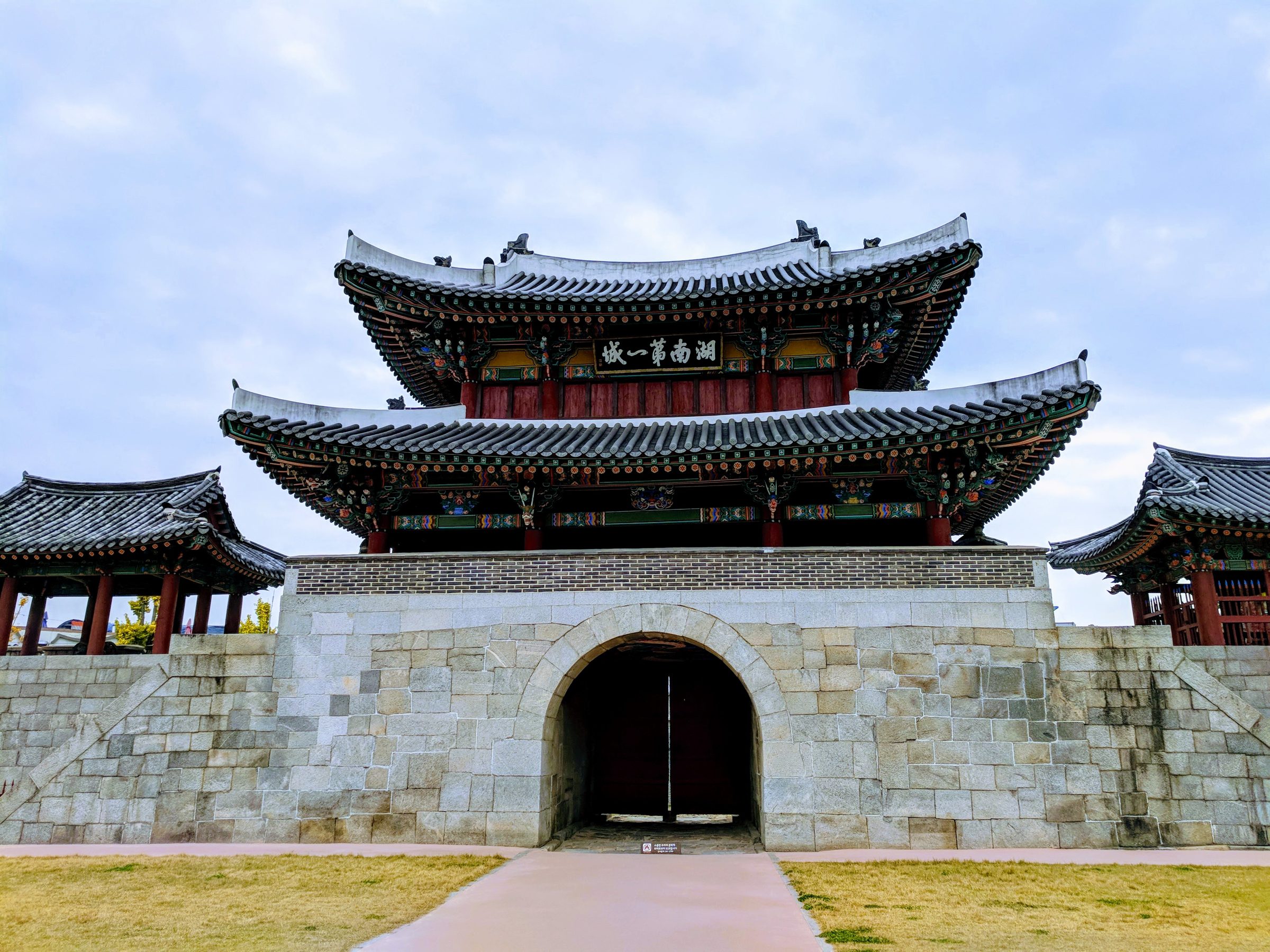 A tiled hanok gatehouse with painted eaves at Jeonju Hanok Village