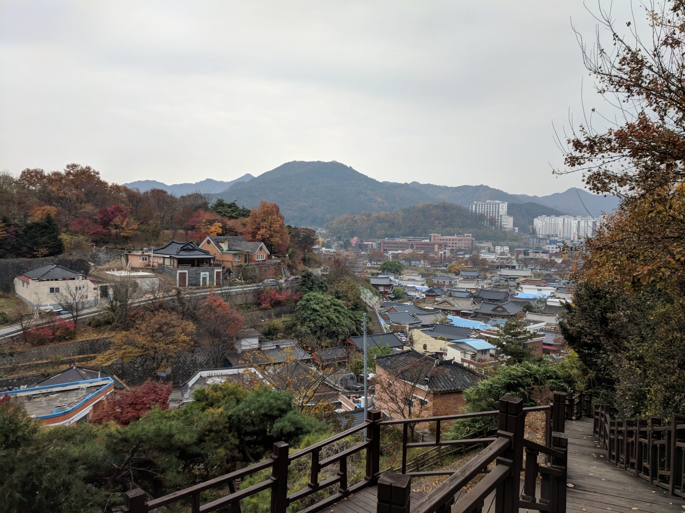 Jeon-Ju spread below a wooded hillside in autumn colour, seen from the trail up Geonjisan Mountain