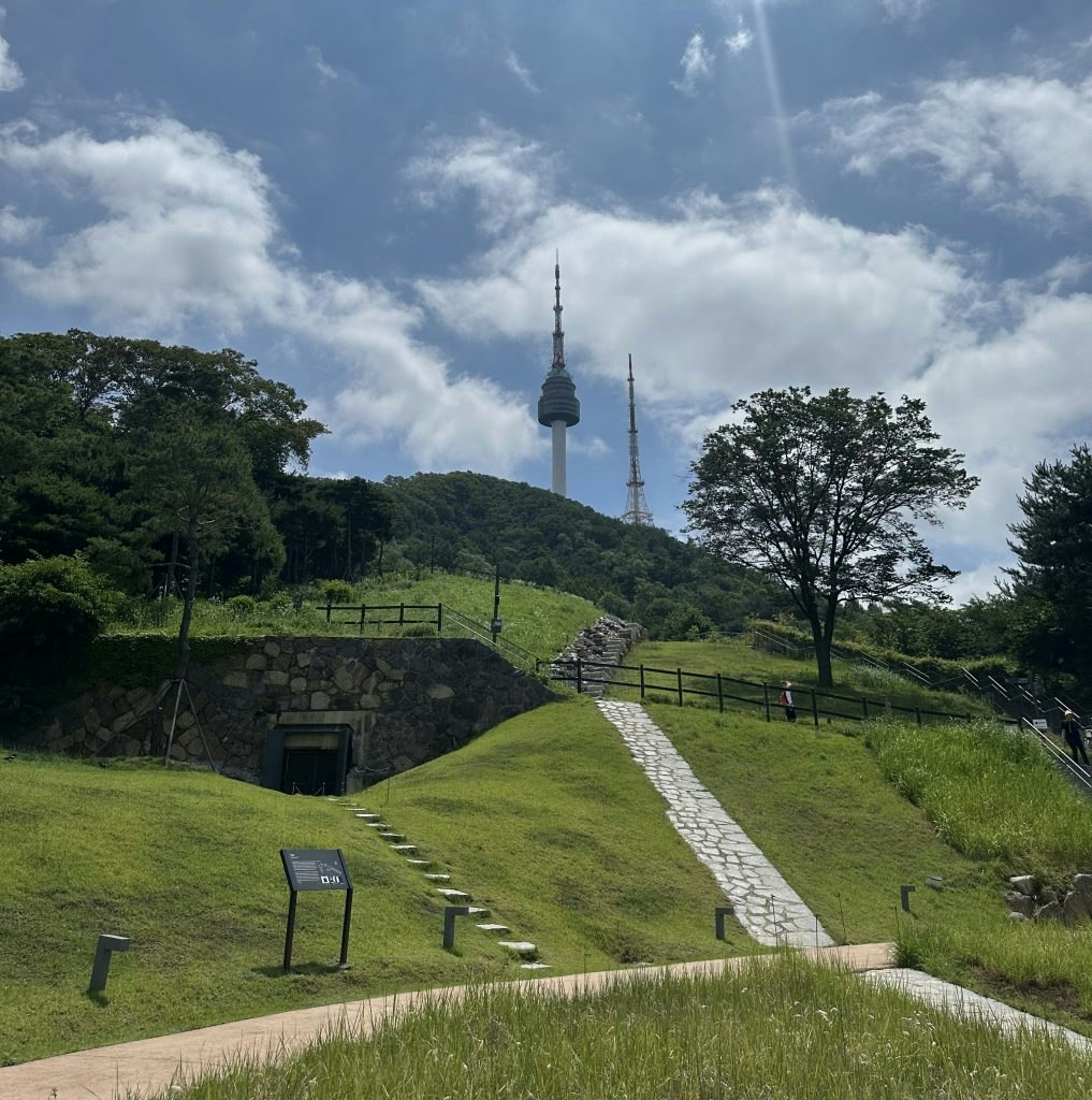View of Namsan Tower with a walking path up to the top, the first of the top things to do in Korea.