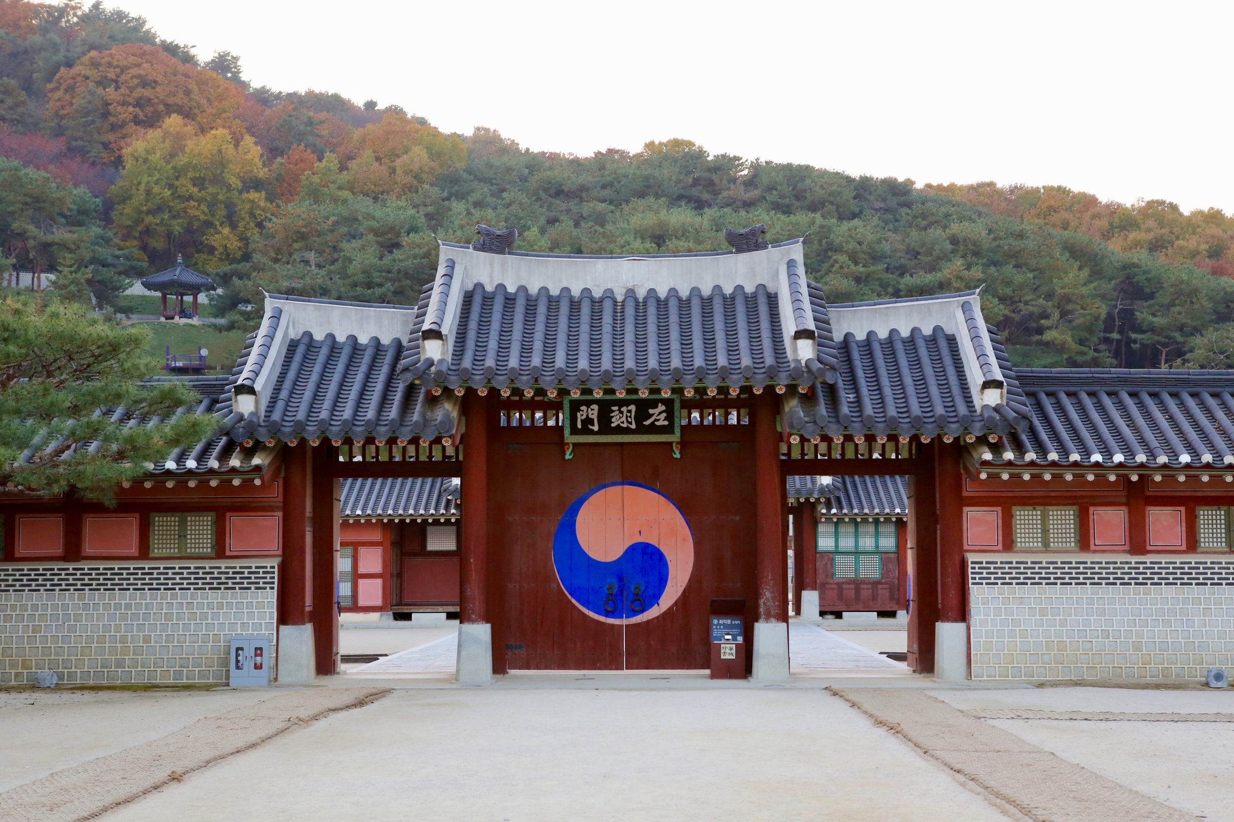 The painted gate of Hwaseong Fortress in Suwon, the taegeuk emblem on its timber doors