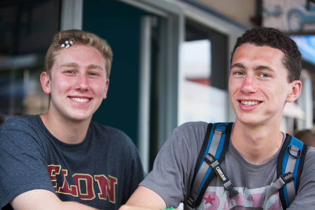 Teen volunteers relaxing between lessons on a teaching volunteer abroad trip.