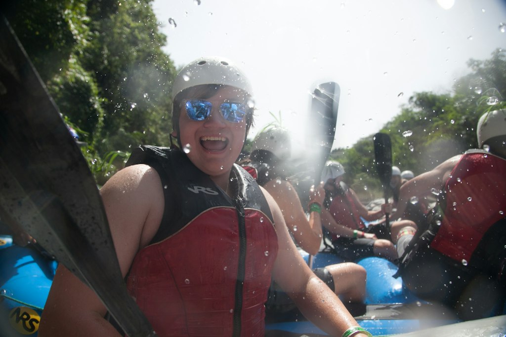 Students whitewater rafting together during a long-term volunteer abroad adventure focused on teamwork and outdoor exploration.