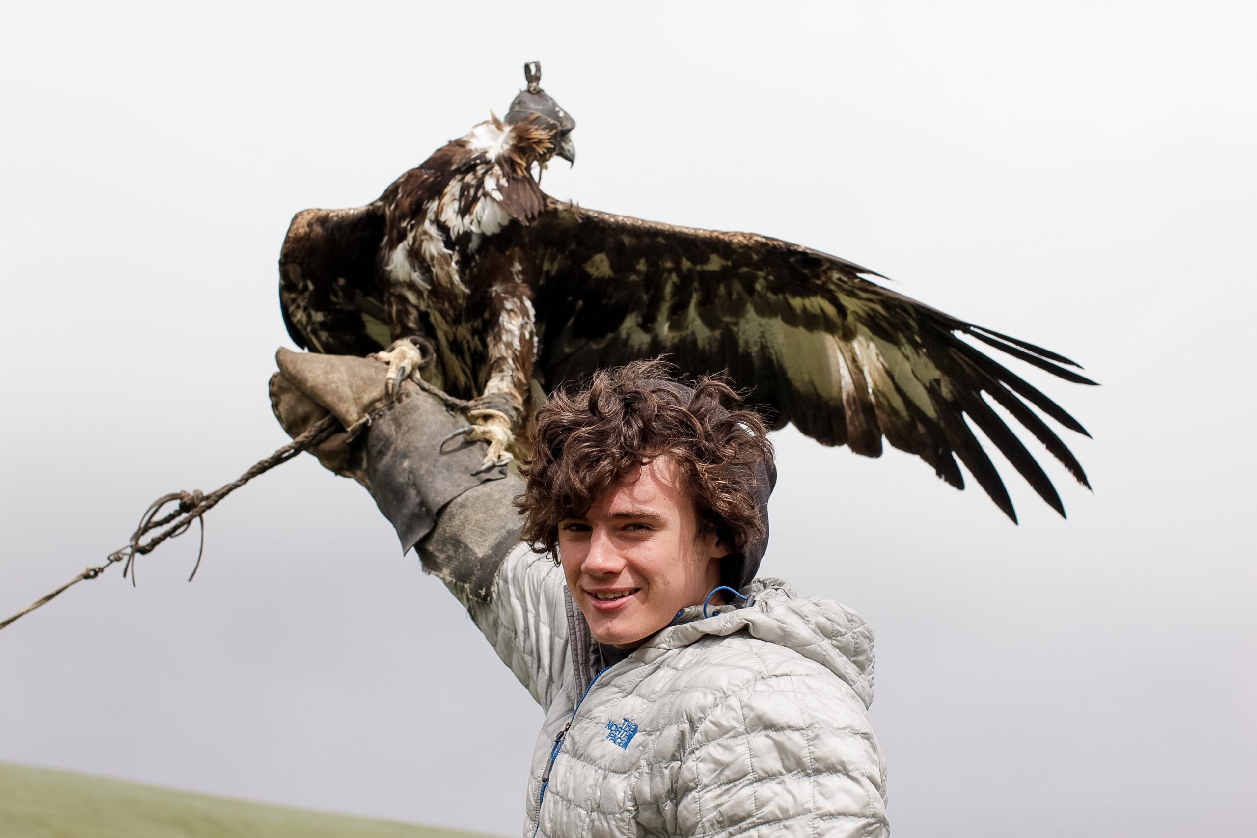 Student participating in eagle training in Mongolia during a Rustic Pathways volunteer abroad program, illustrating cultural exchange and transformative volunteer abroad reviews.