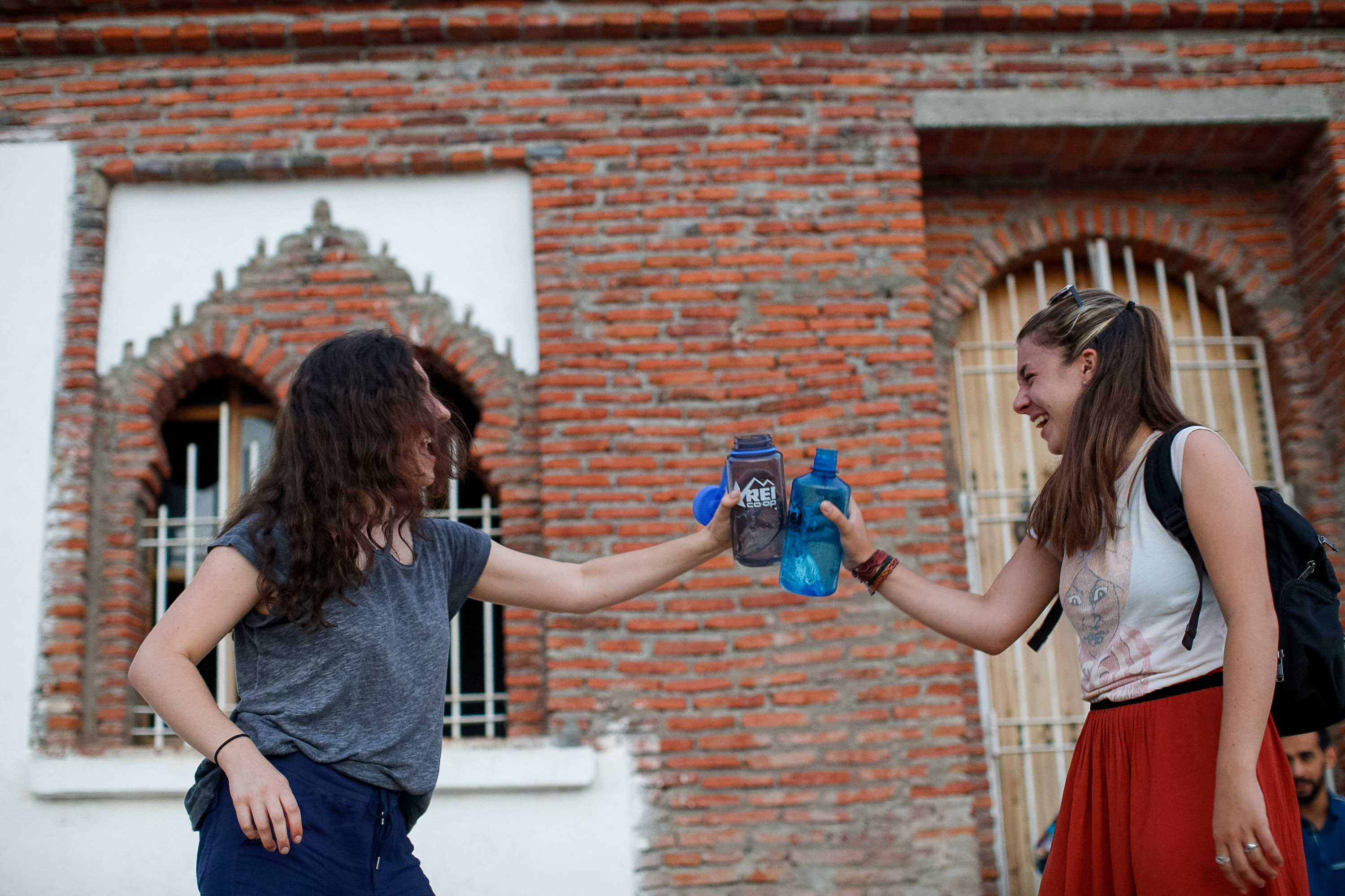 student travelers with reusable water bottles