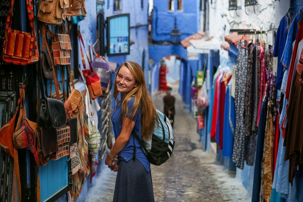 A student traveler posing in the blue streets of Morocco on a teen tour in Africa with Rustic Pathways