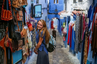 A student explores the blue streets of a Moroccan town during a Morocco teen tour