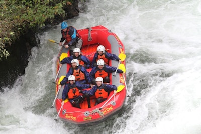 A group of students whitewater rafting on an adventure teen tour to New Zealand