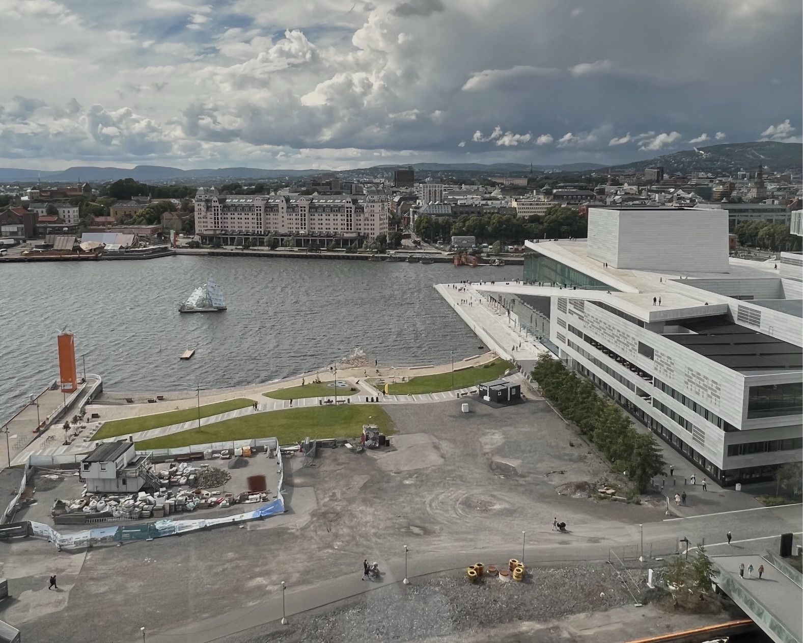 Student travelers take in Oslo's waterfront, where the Opera House and harbor stretch out beneath a cloudy sky