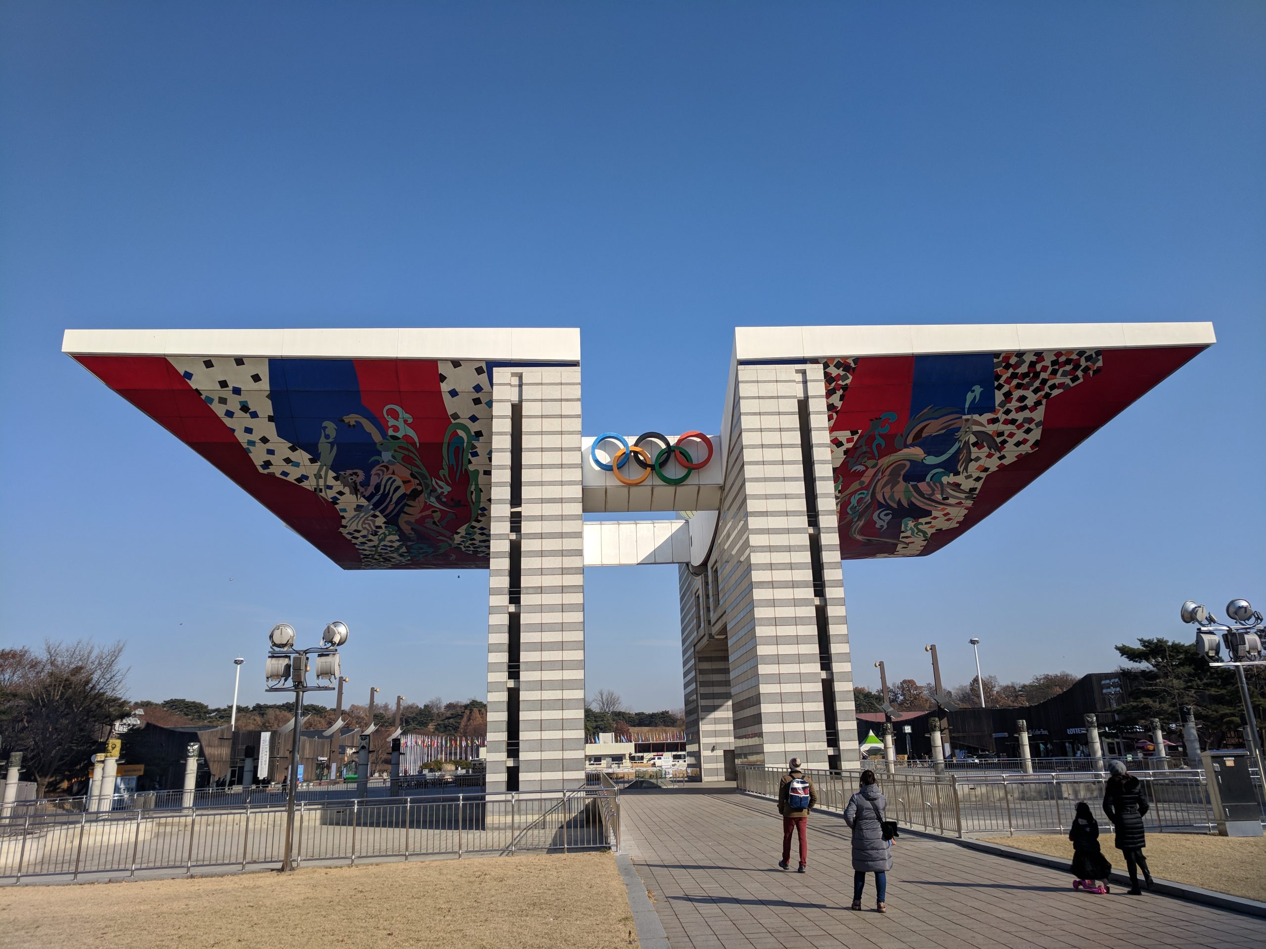 Entrance to Olympic Park in Seoul with the Olympic rings and decorative roof.