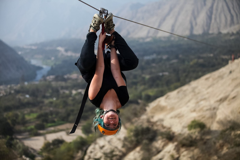 Student ziplining through the Andes Mountains during a Rustic Pathways volunteer abroad in Latin America program combining adventure and service.
