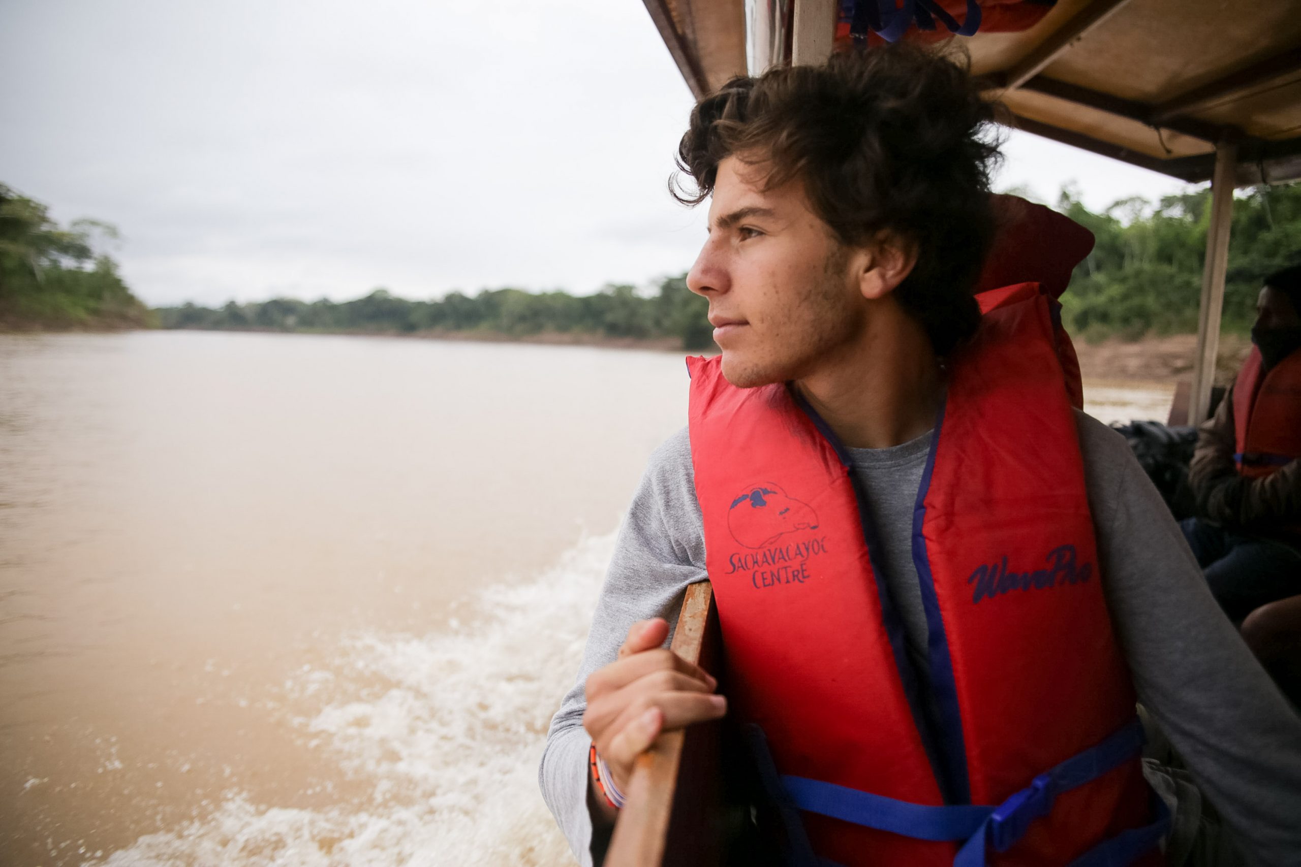 Student on a boat looking towards the lake.