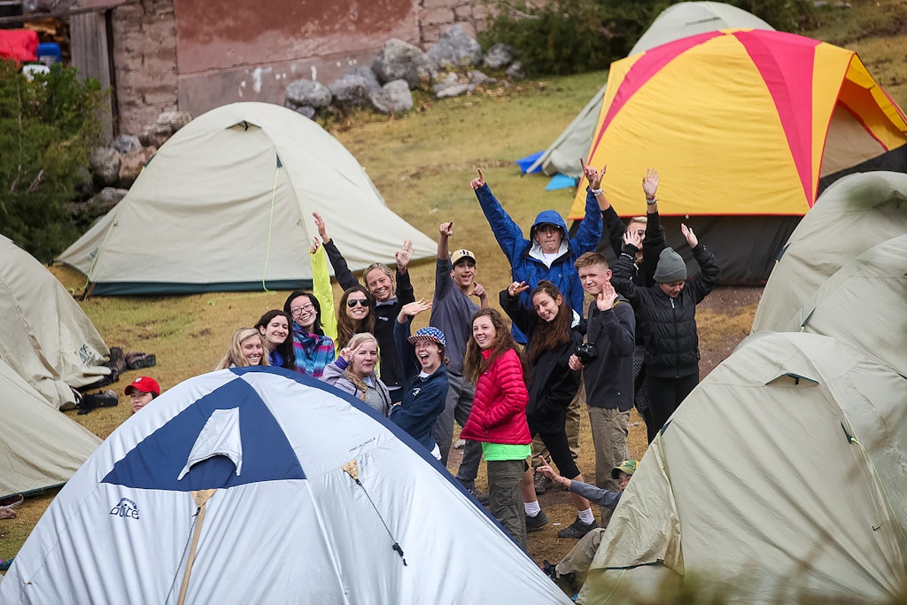 Students camping and posing for the camera.