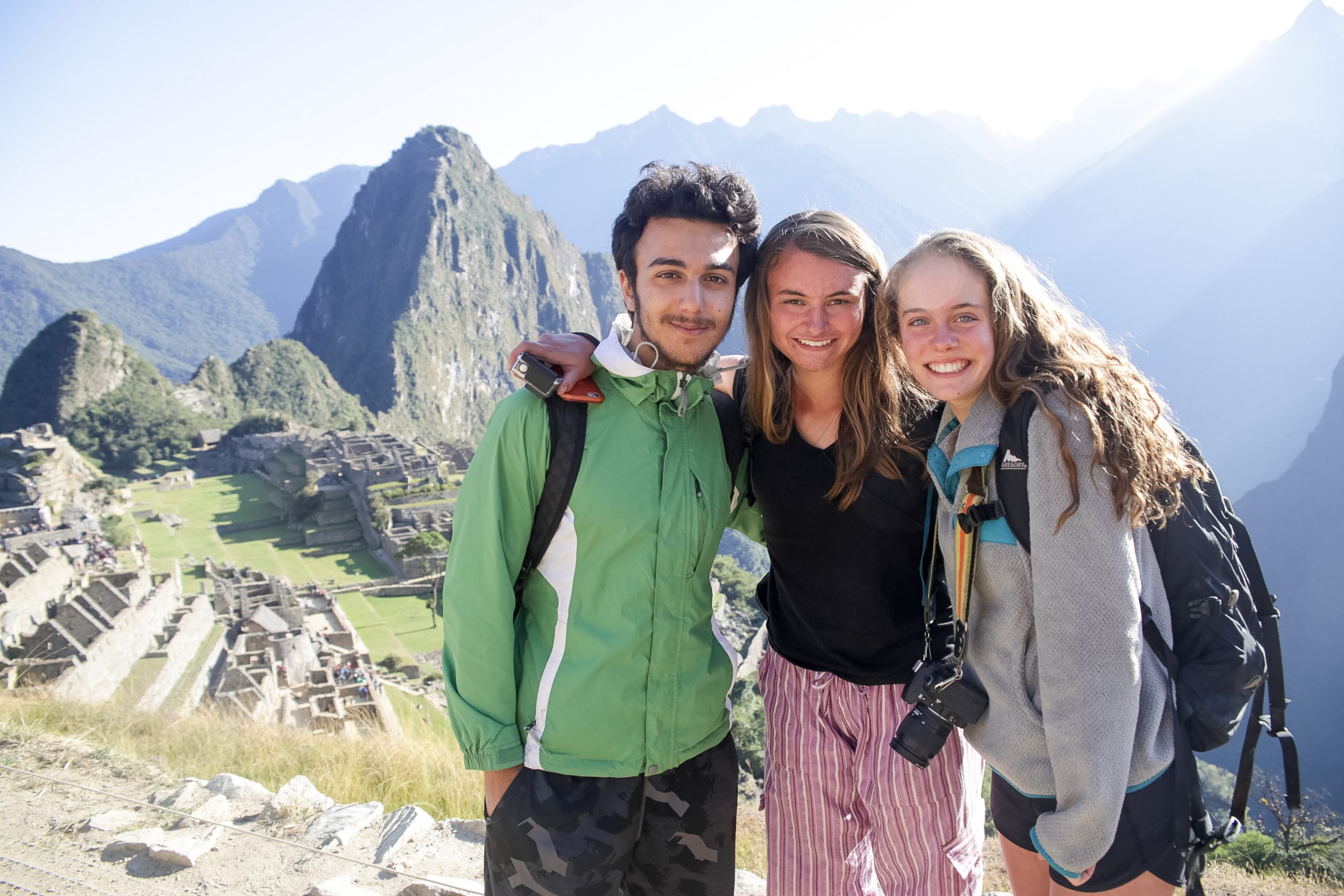 Group of students psoing with mountains in the background in Peru.