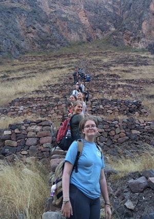 Students on a teen travel program in a single file line during a hike in the mountains of Peru.