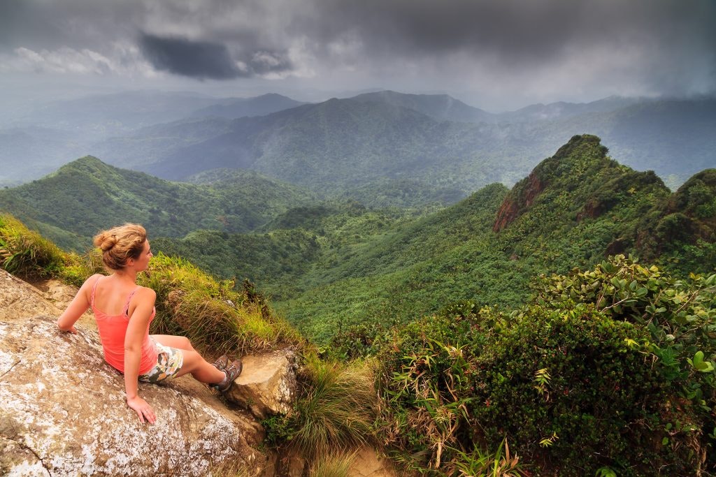 Fun Facts About Puerto Rico Woman enjoying the view of El Yunque National Forest in Puerto Rico
