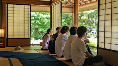 Students participating in cultural reflection at a traditional Japanese house during a teen travel program to Tokyo