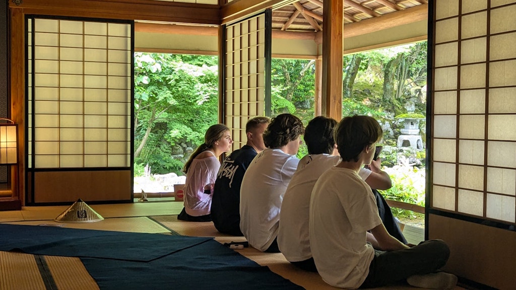 Students sit inside a traditional Japanese room looking out into the garden. Learn more fun facts about Tokyo.