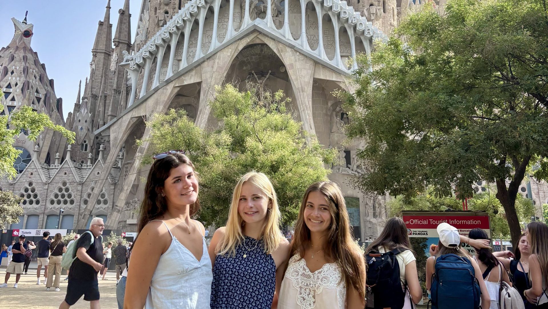 Three travelers posing together in front of the Sagrada Familia in Barcelona, Spain