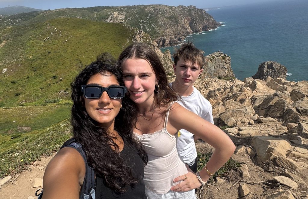 Three teen travelers posing on a cliffside during a Portugal teen tour.