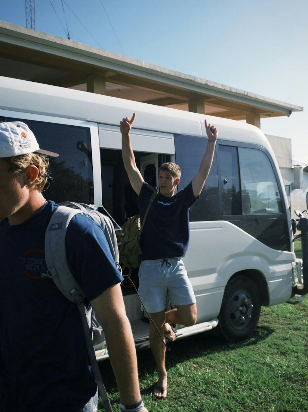 Students step out of the van full of energy.