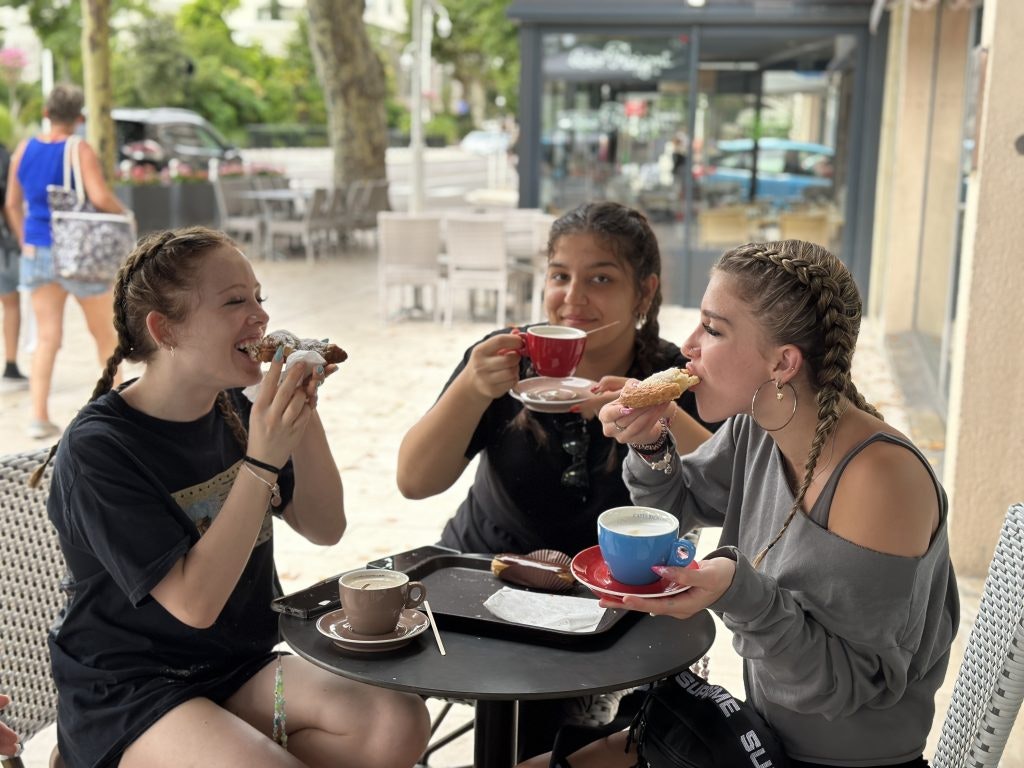 Rustic Pathways students take a break at a local bakery in France.