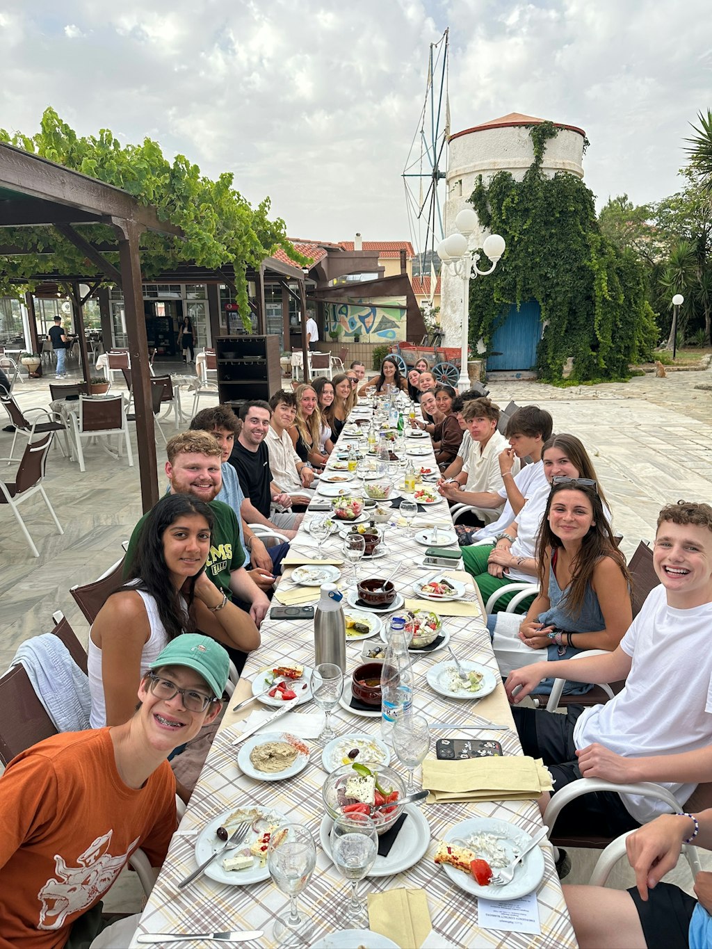 Students sharing a group meal abroad, symbolizing how travel builds college readiness through cultural connection, teamwork, and communication skills.