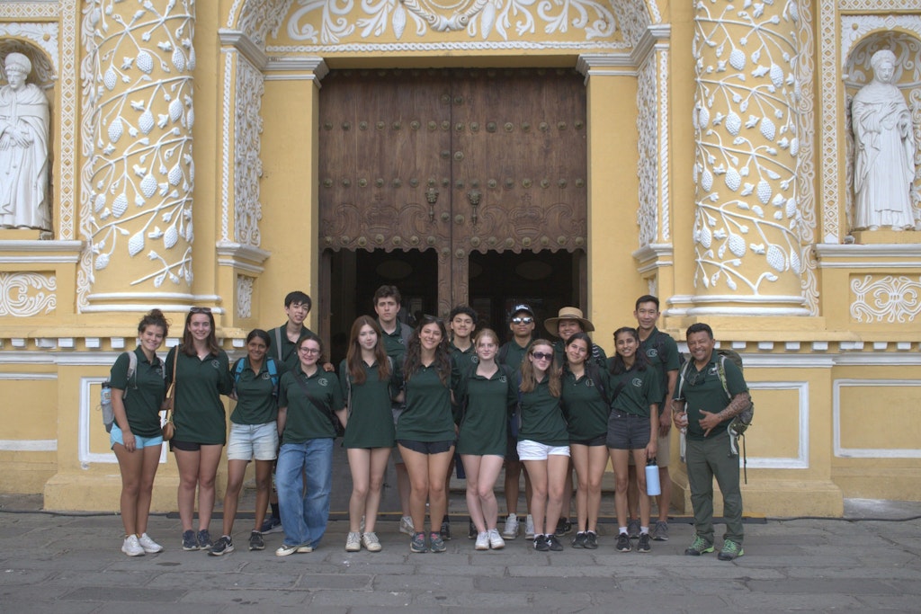 Student volunteers standing in front of a historic church in Guatemala during a Rustic Pathways volunteer abroad in Central America program focused on cultural immersion and service.