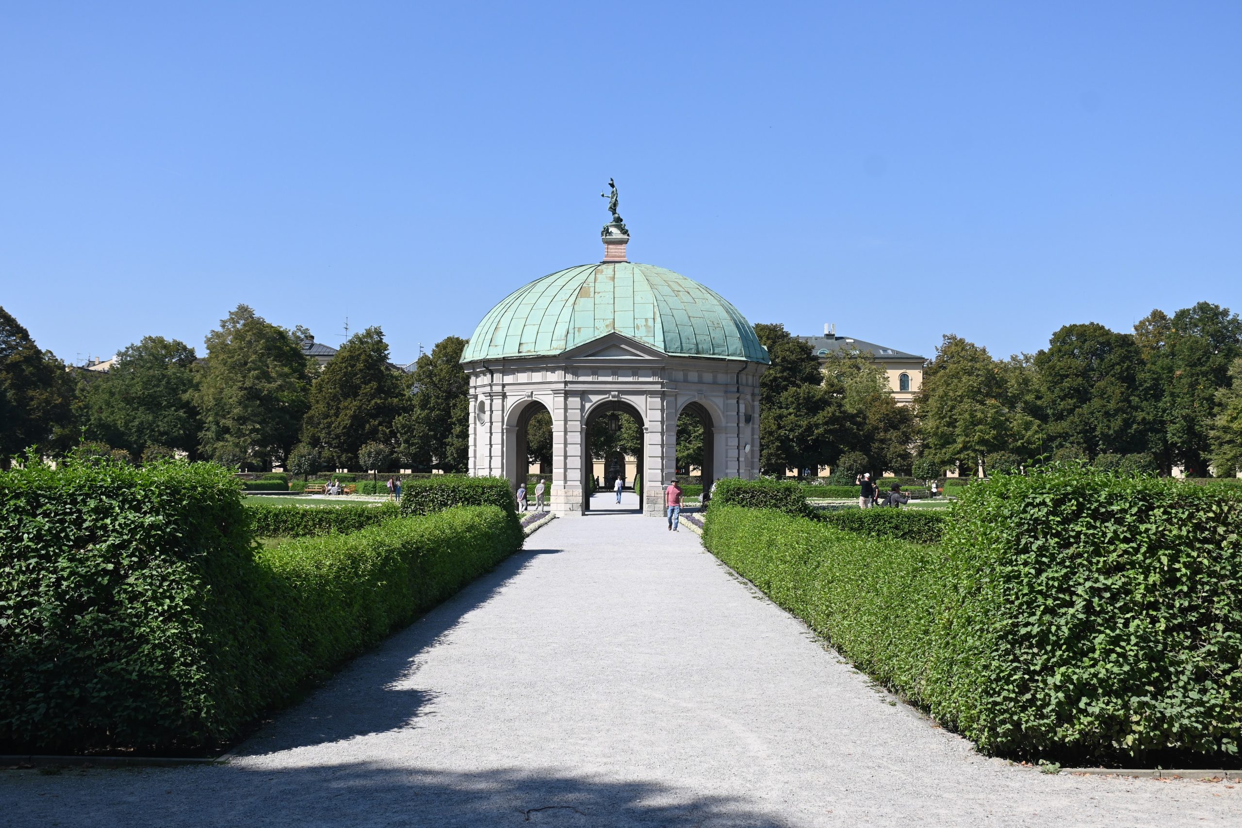 A park with a domed pavilion and manicured gardens.