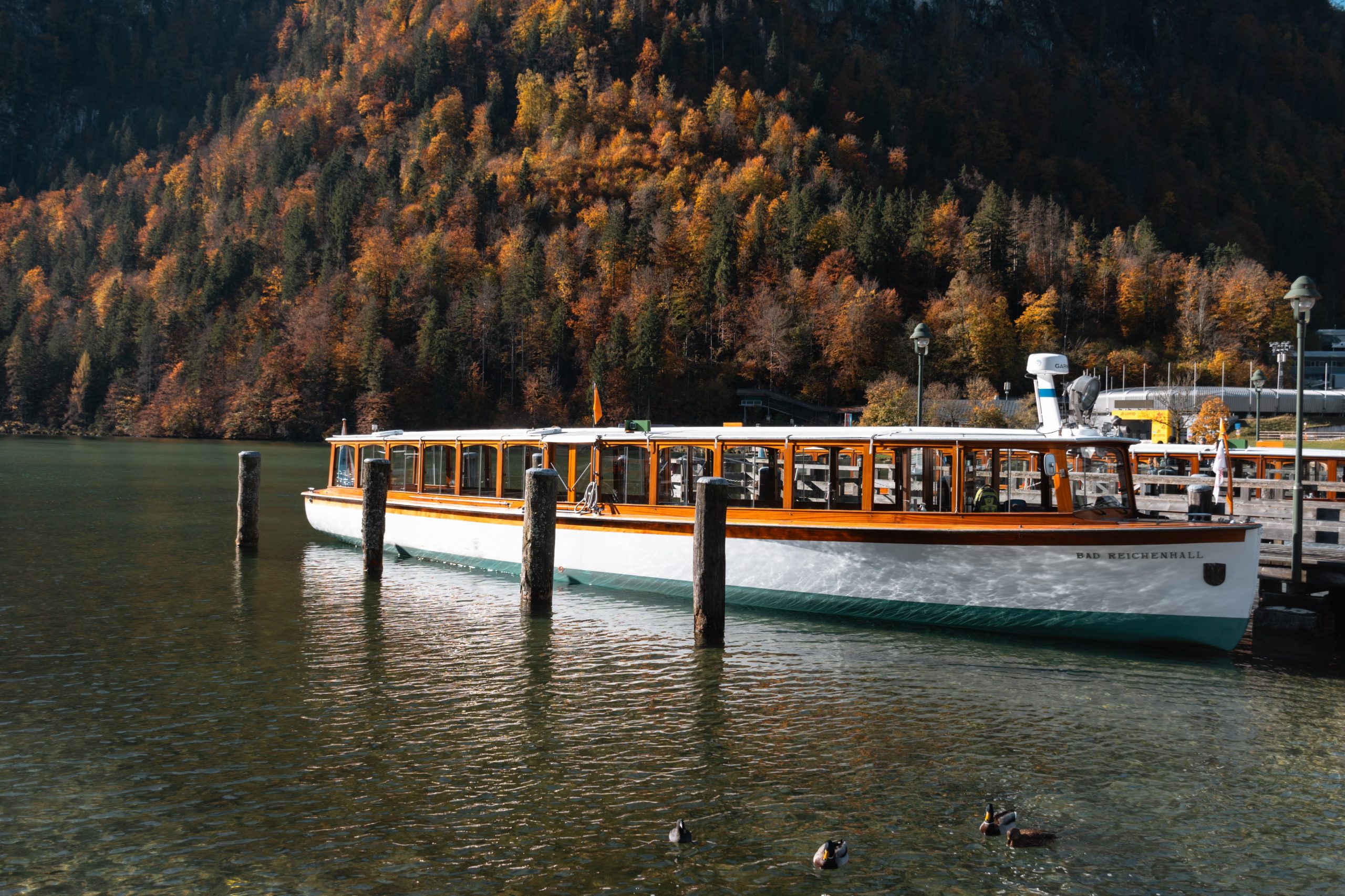 A scenic mountain lake with a docked ferry.