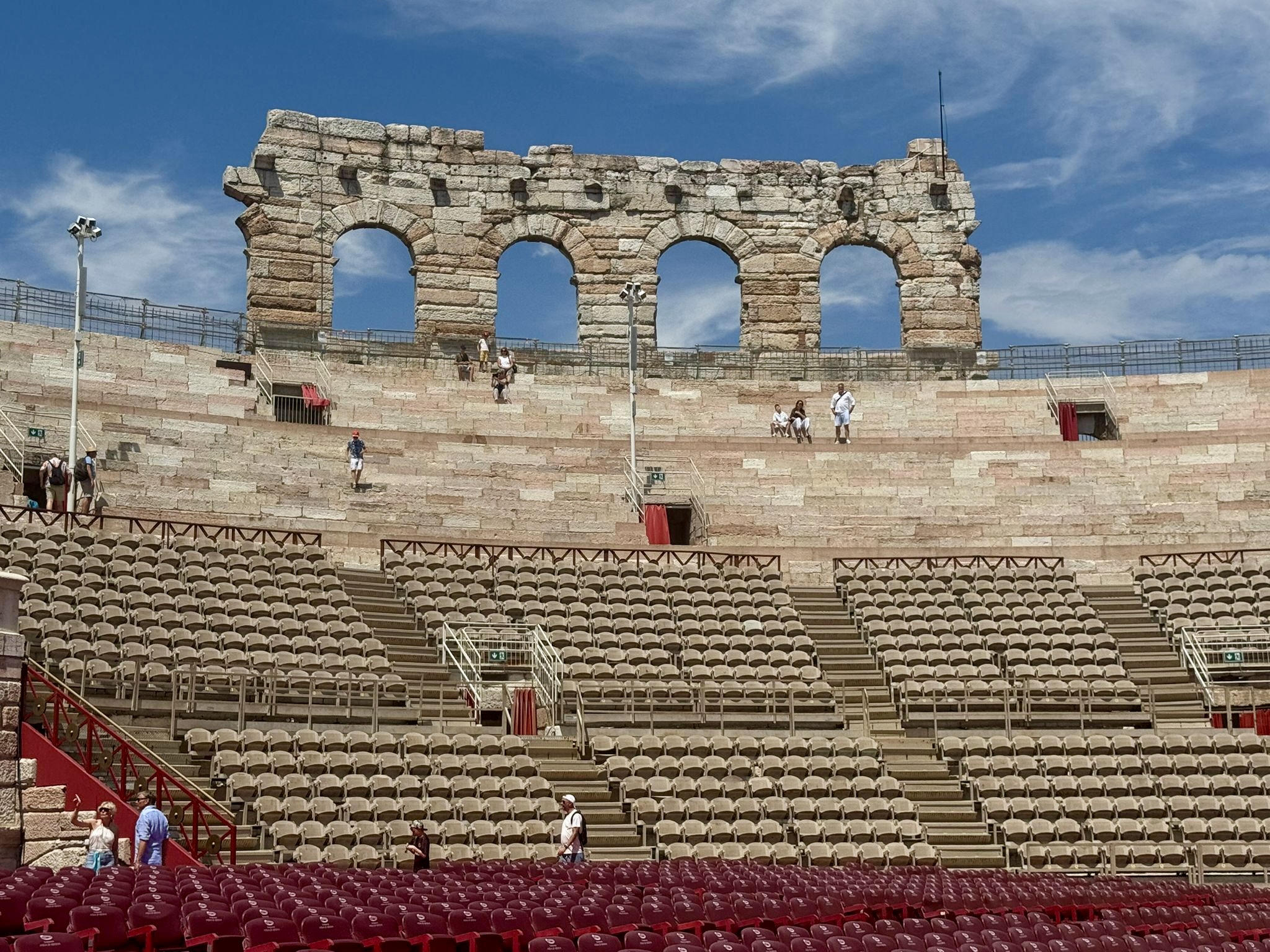 Ancient stone arches rise above the tiered seating of the Verona arena