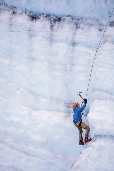 a student traveler safely climbing a snowy mountain