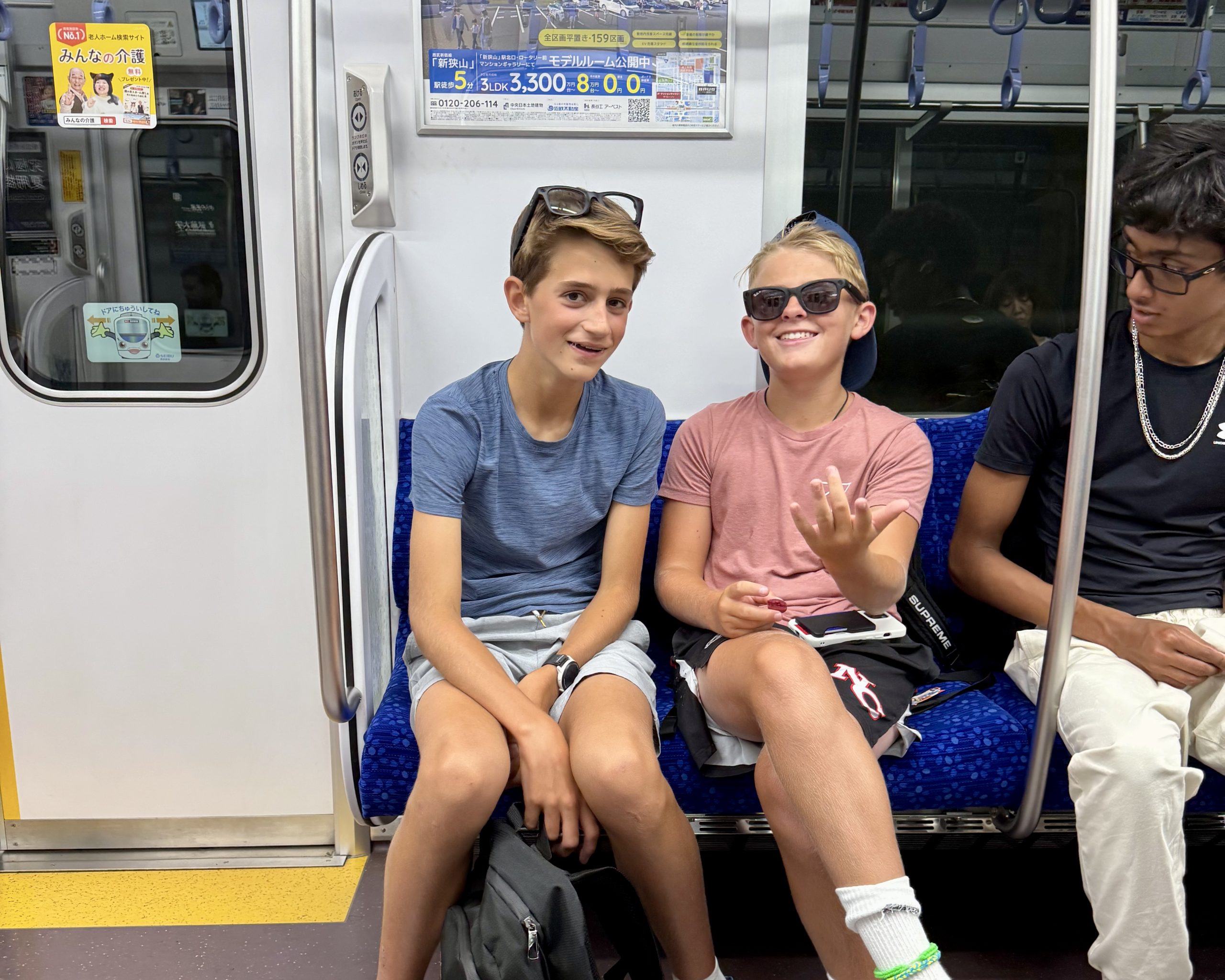 Students chat and laugh while riding a Japanese train