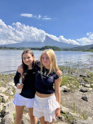 Two students pose in front of Mount Fiji in Tokyo, Japan during a summer teen tour.