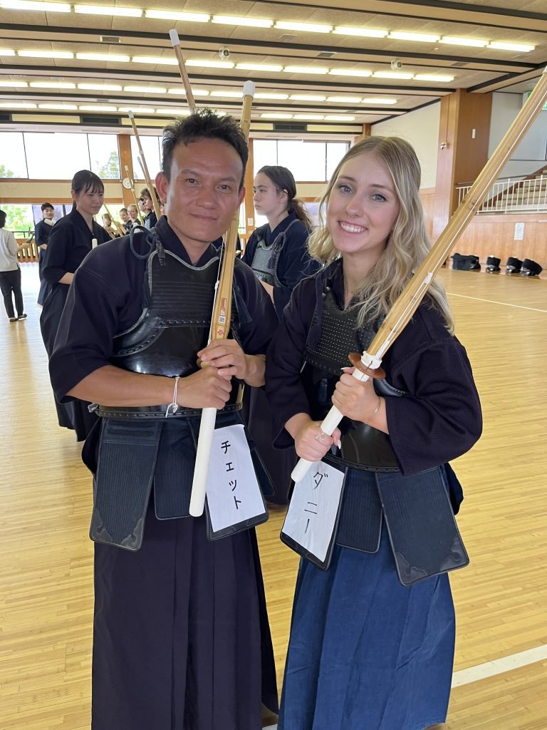 A female student and Japanese instructor smile together during a Kendo experience on a cultural immersion teen tour to Japan.