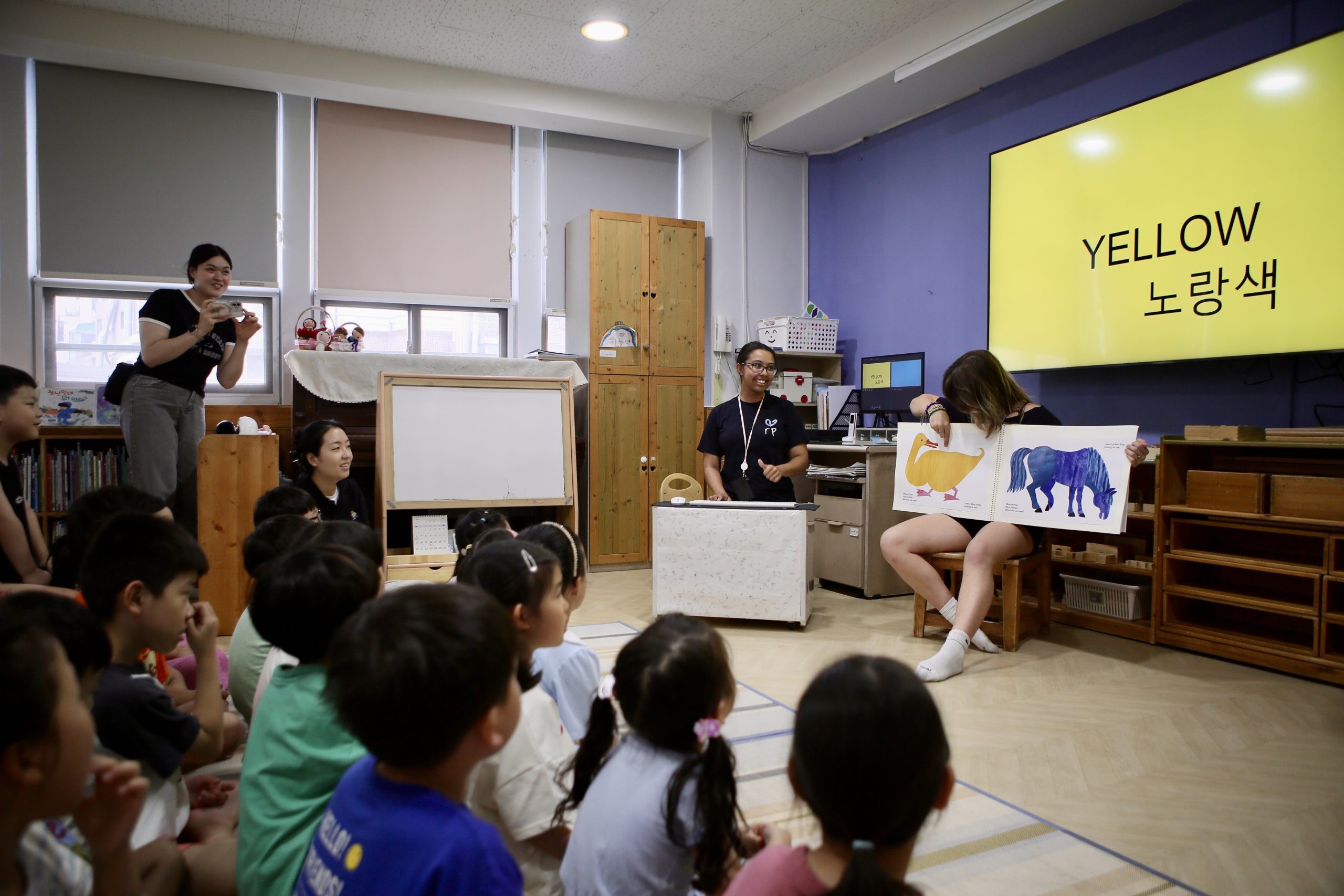 Students work with local children in a classroom during a school exchange placement