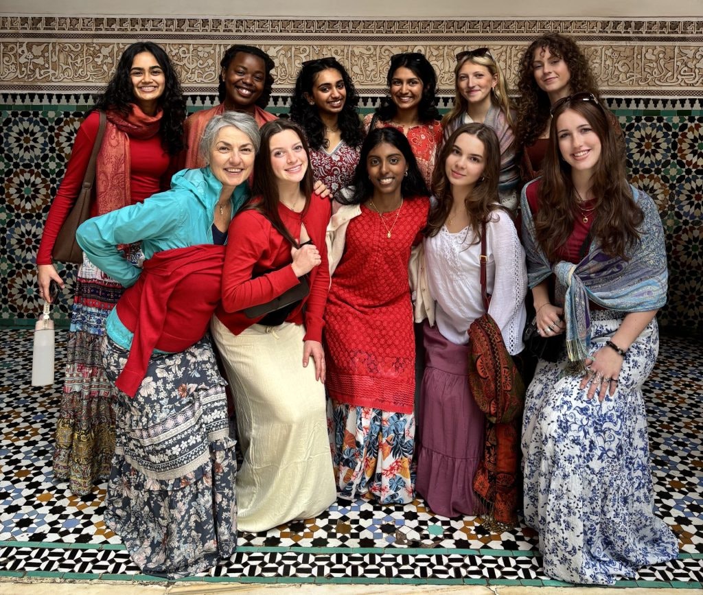 A group of student travelers dressed in traditional Moroccan clothing during a teen tour in Africa.