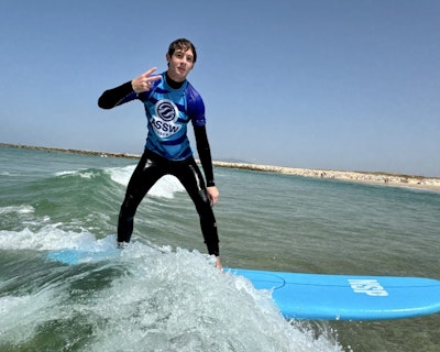 a student surfing in Portugal during a teen tour to Italy and Portugal