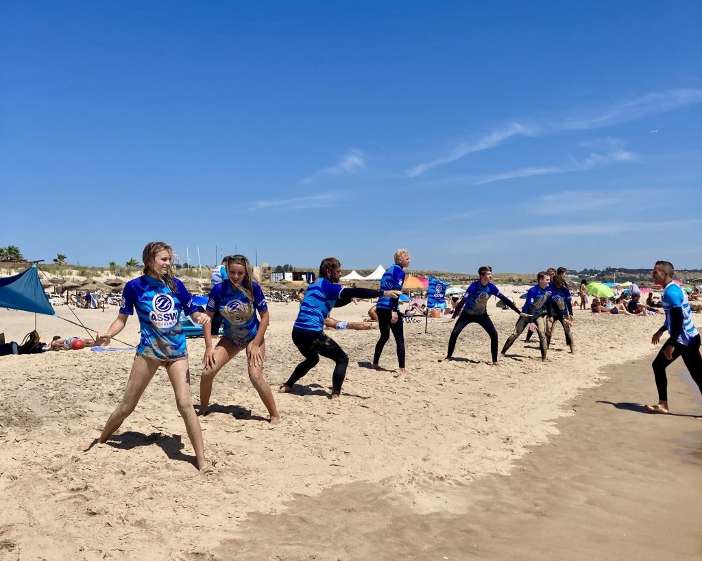 A group of students get a surf lesson on the beach during a Spain teen tour