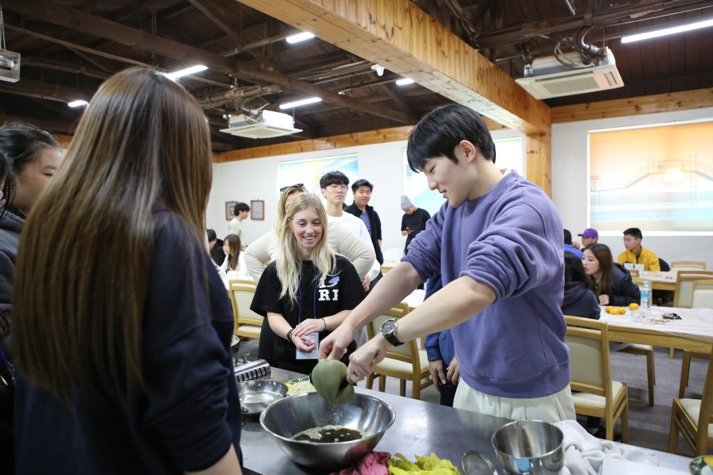 Rustic Pathways Program Leader working alongside students in the field.