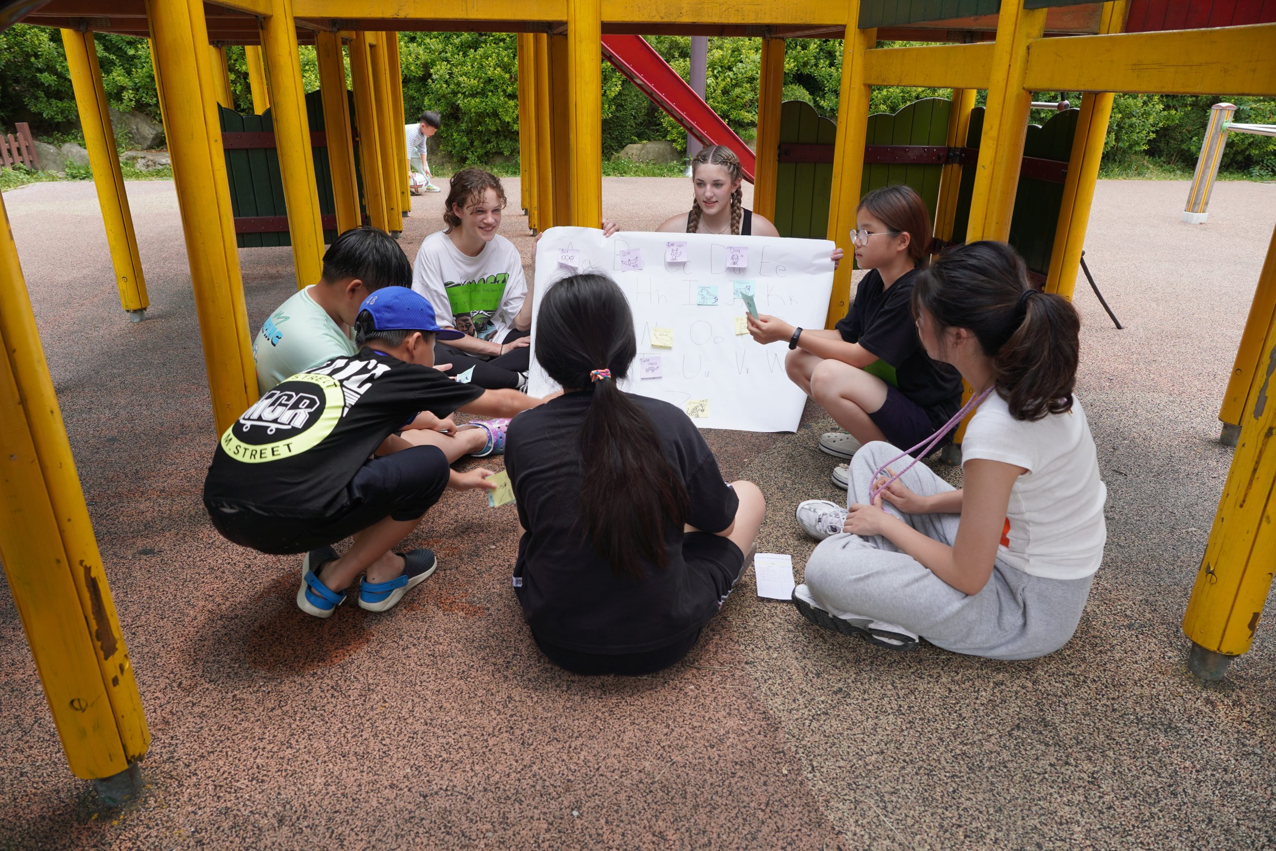 Students work together outdoors during a scavenger-hunt activity.